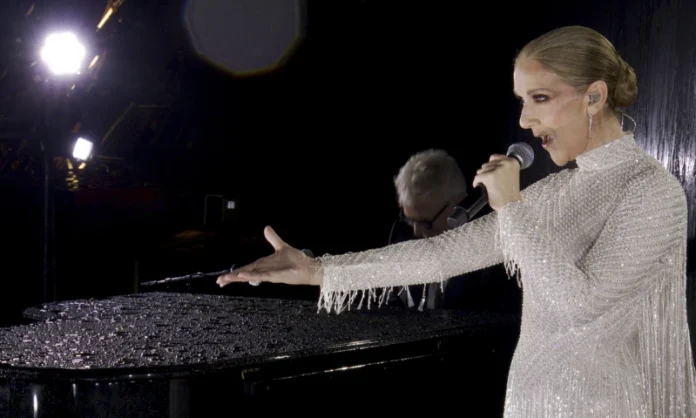 This photo released by the Olympic Broadcasting Services shows Canadian Singer Celine Dion performing at the Eiffel Tower during the opening ceremony for the 2024