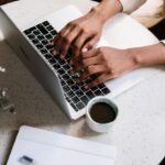 Blogging Blogger typing on a laptop